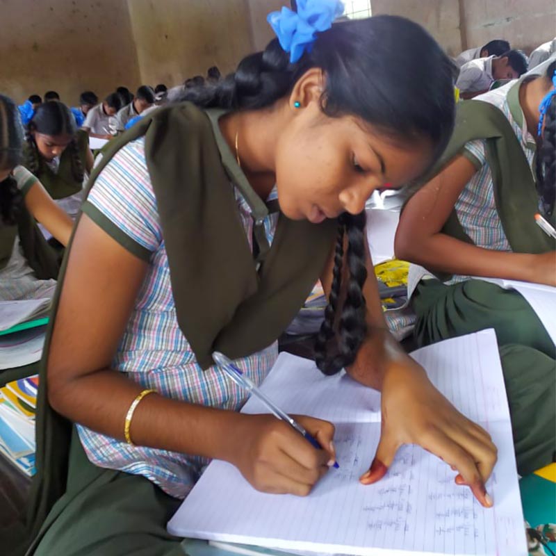 Students writing notes in a classroom