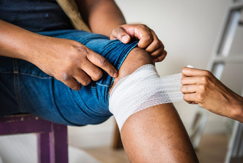 A woman performing first aid on a patient