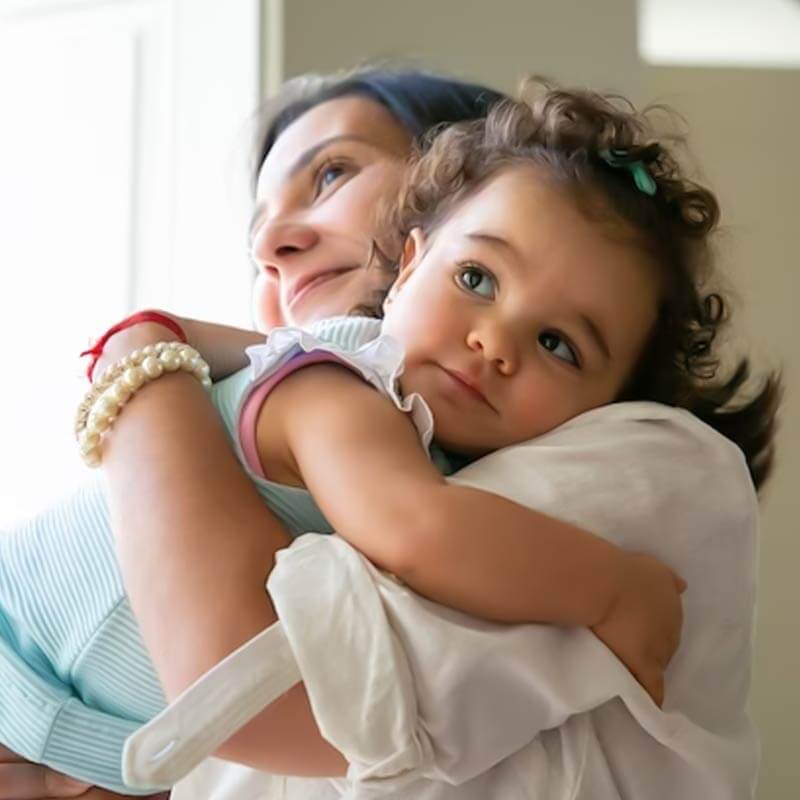 A mother holding a baby Adoption filaantro