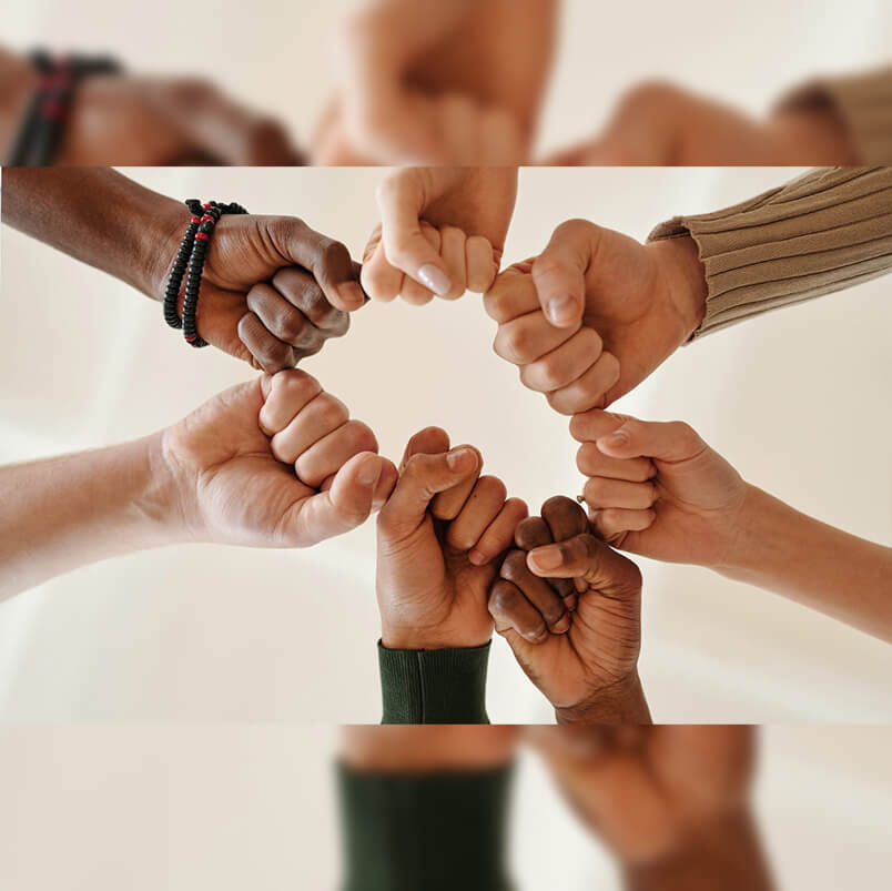 Human hands of different races coming together to show solidarity