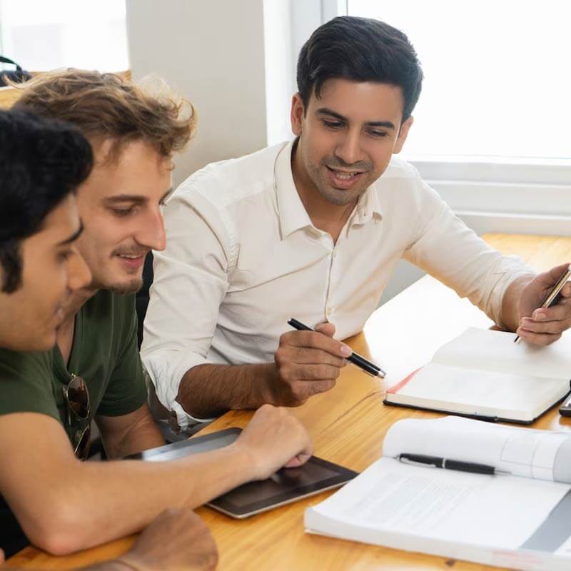 young teacher telling two students about corporate budgeting